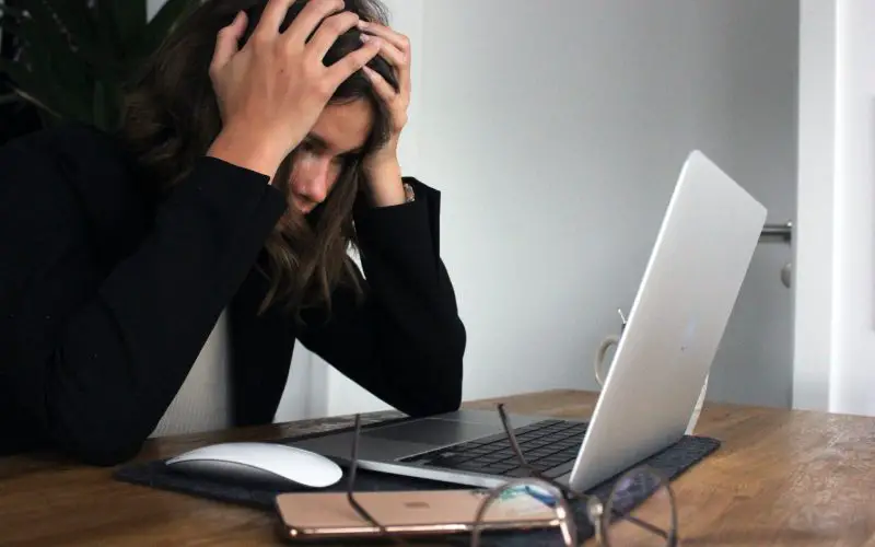 Frustrated woman in front of laptop