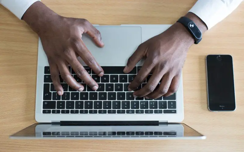 Closeup photos of hands on laptop Mac keyboard